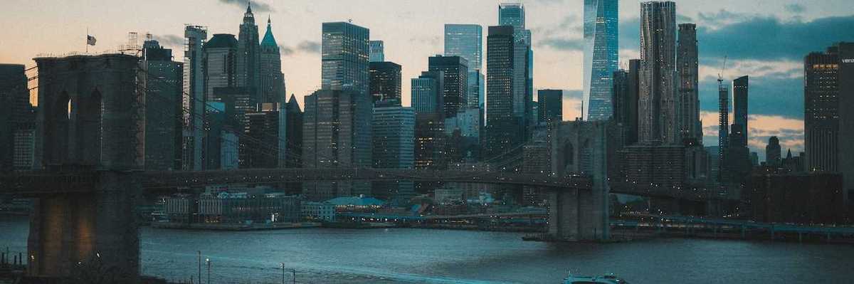 Boat traveling on a NYC waterway with Manhatten skyline in background