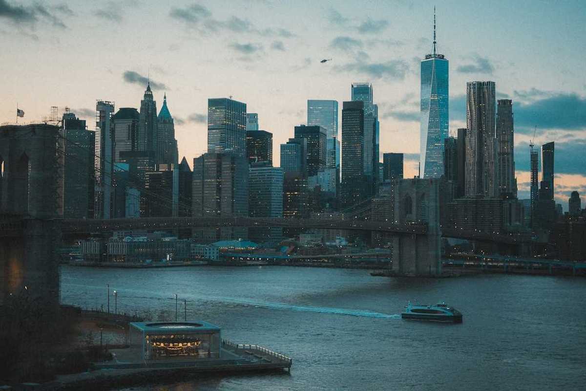 Boat traveling on a NYC waterway with Manhatten skyline in background