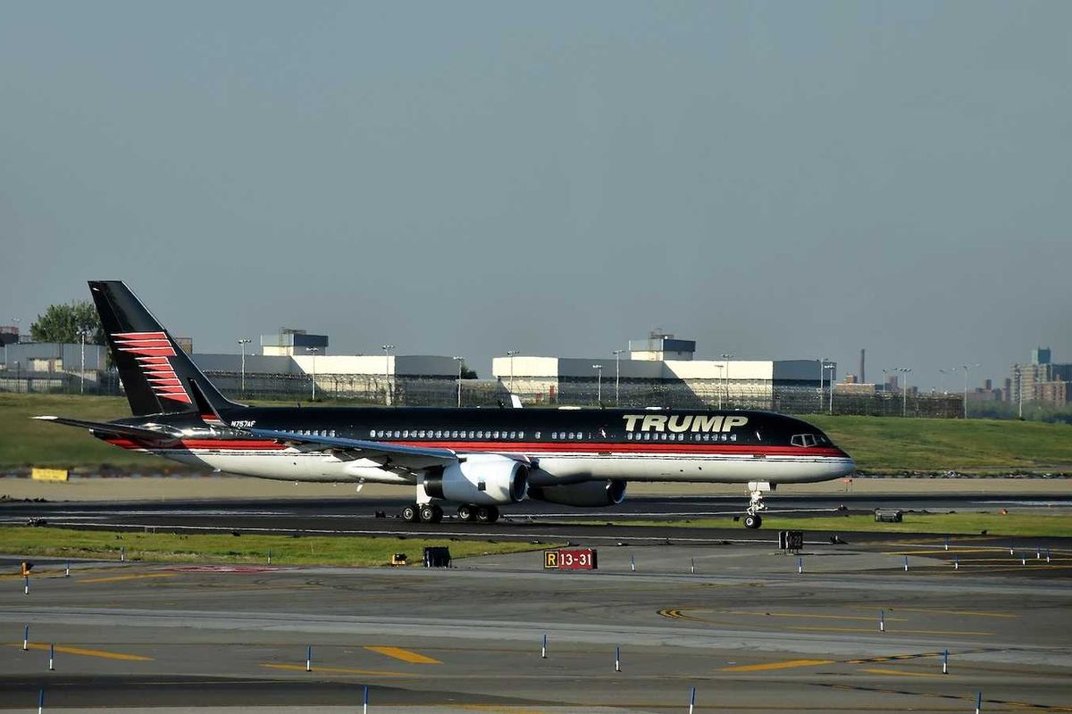 Boeing 757 jet airplane bearing the logo of Donald Trump takes off from Laguardia New York City