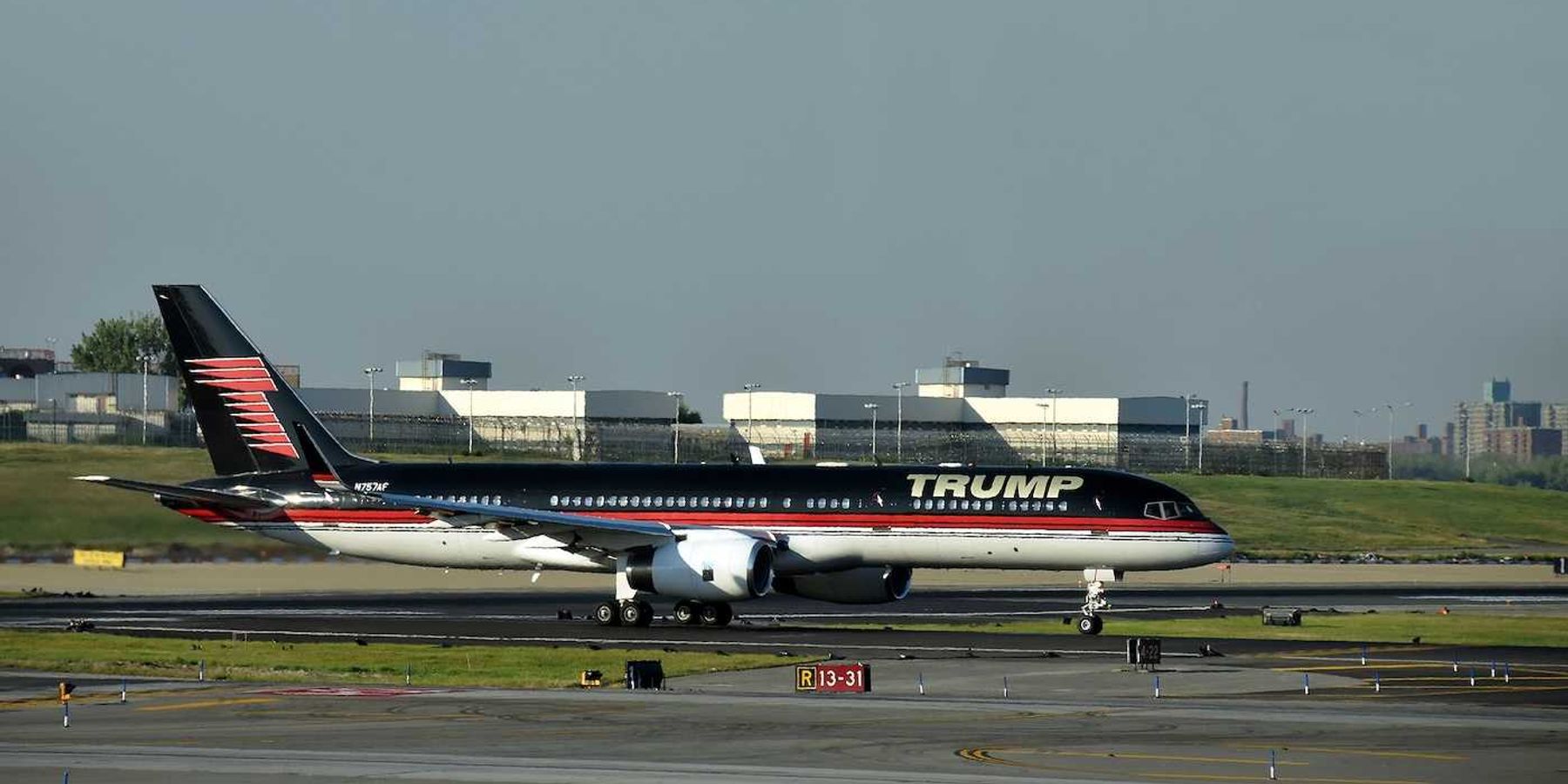 Boeing 757 jet airplane bearing the logo of Donald Trump takes off from Laguardia New York City
