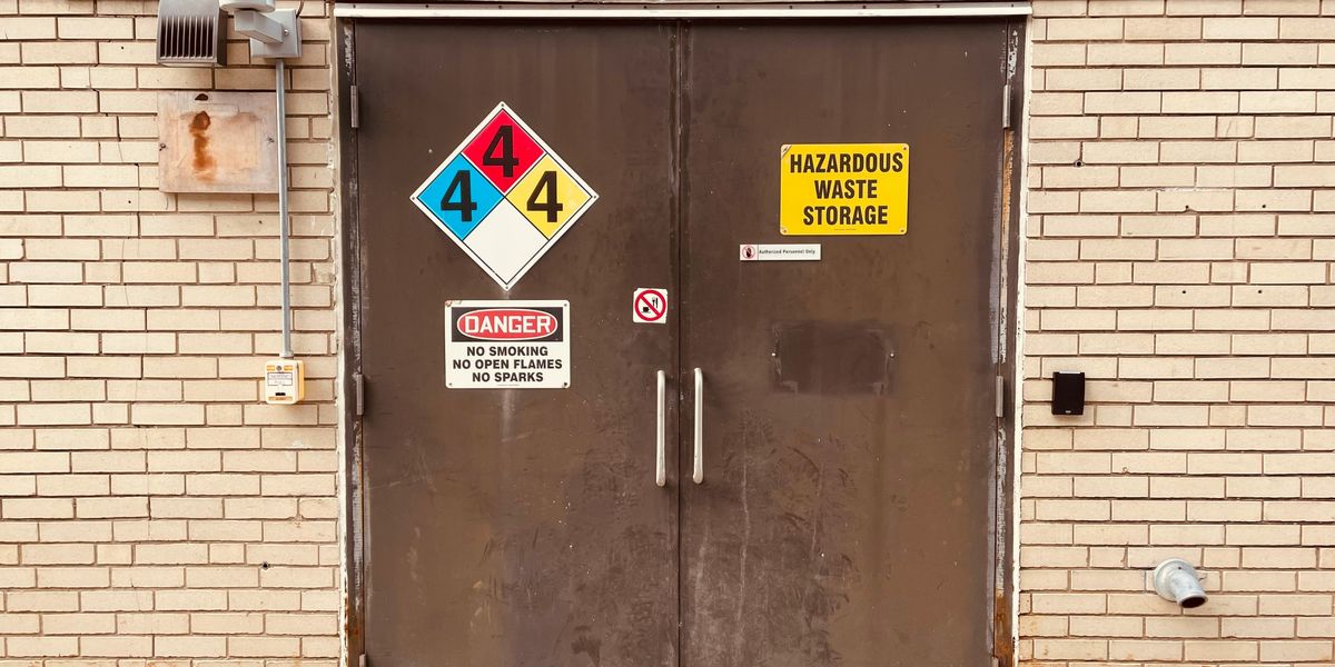 Brown doors with hazardous waste sign on them