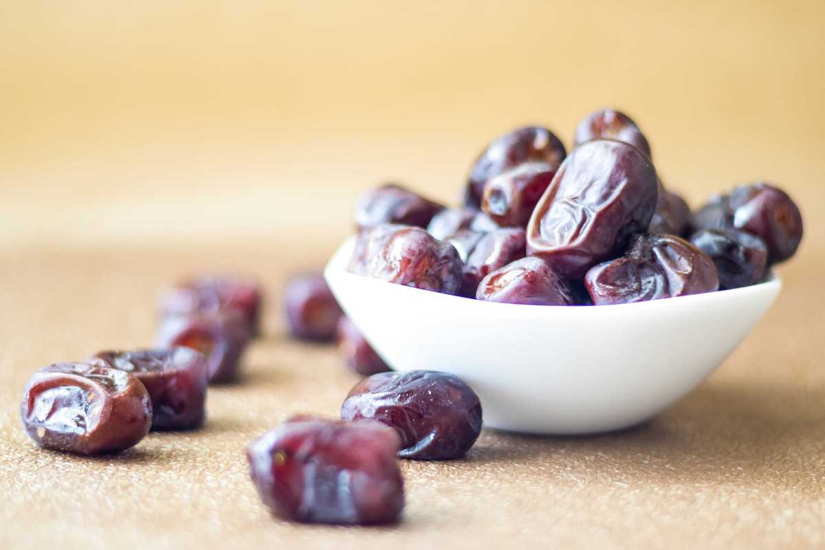 brown round fruit in white ceramic bowl