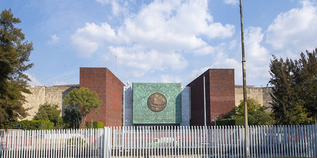 building in Mexico with white fence around it