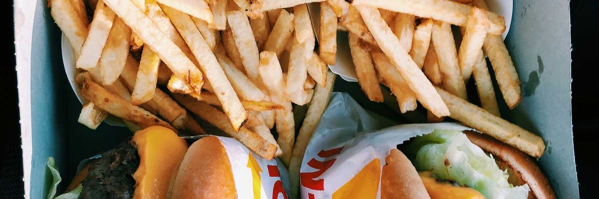 burgers and fries inside box.