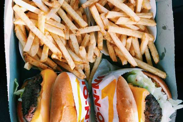 burgers and fries inside box.