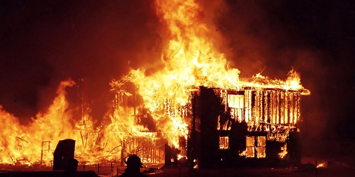 Burning building engulfed in flames.