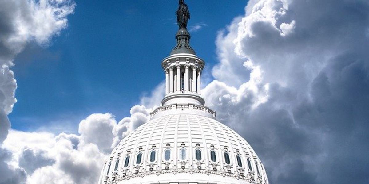 Capitol dome in Washington DC against a cloudy sky.