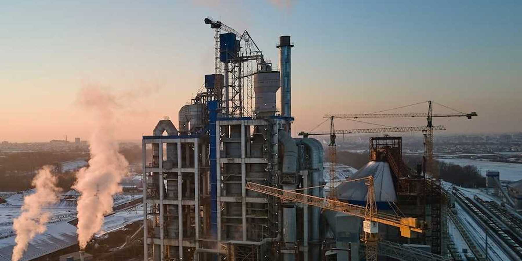 Cement plant flanked by three massive cranes
