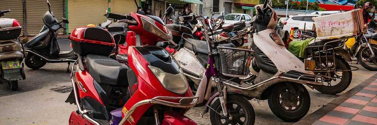Chinese electric motorcycle parked in downtown district.
