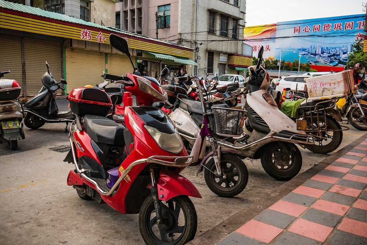 Chinese electric motorcycle parked in downtown district.