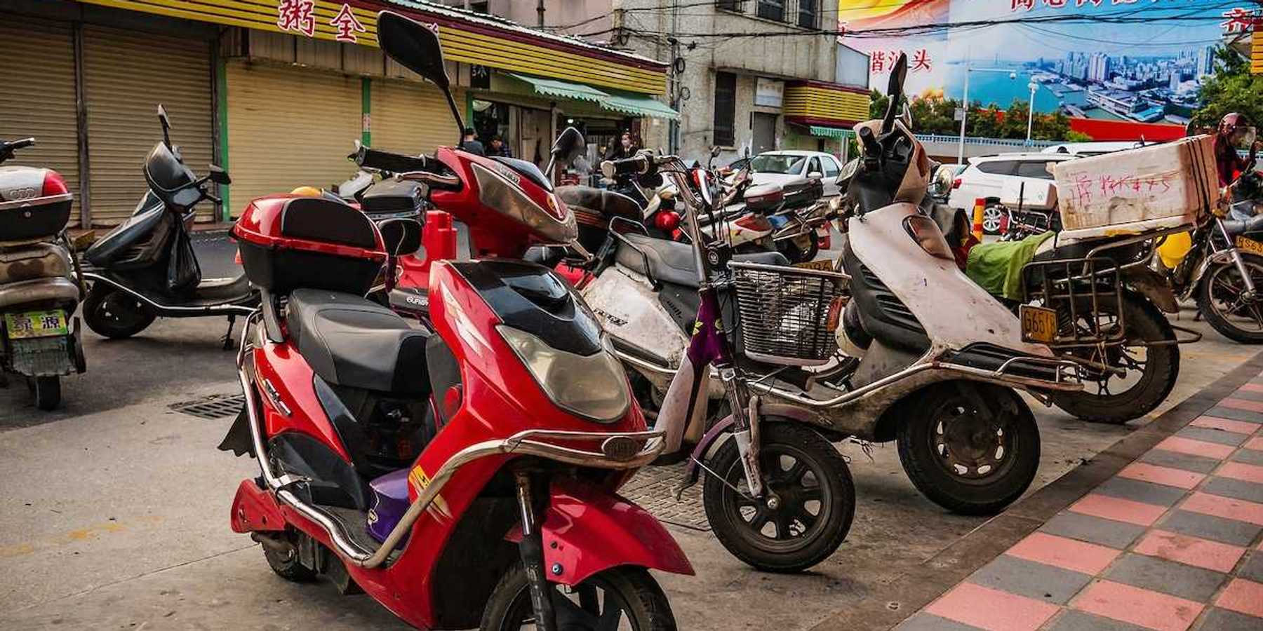 Chinese electric motorcycle parked in downtown district.