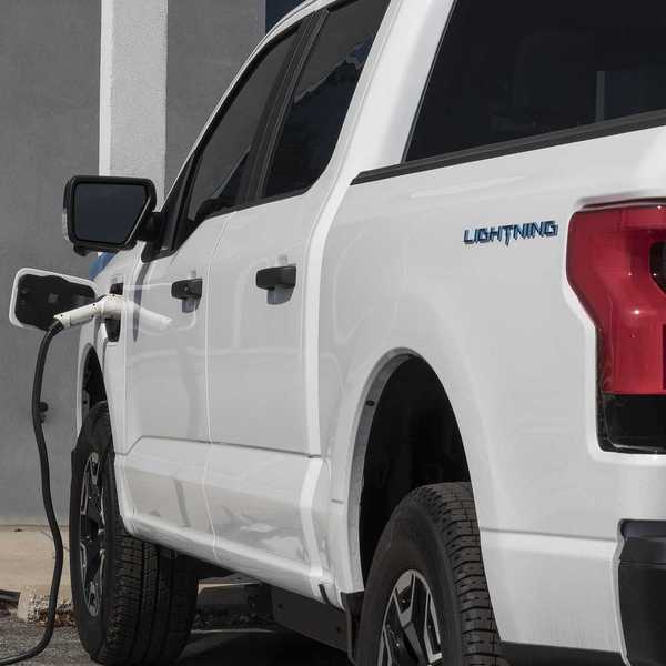 Circa September 2022: Ford F150 Lightning all-electric truck connected to EV charger