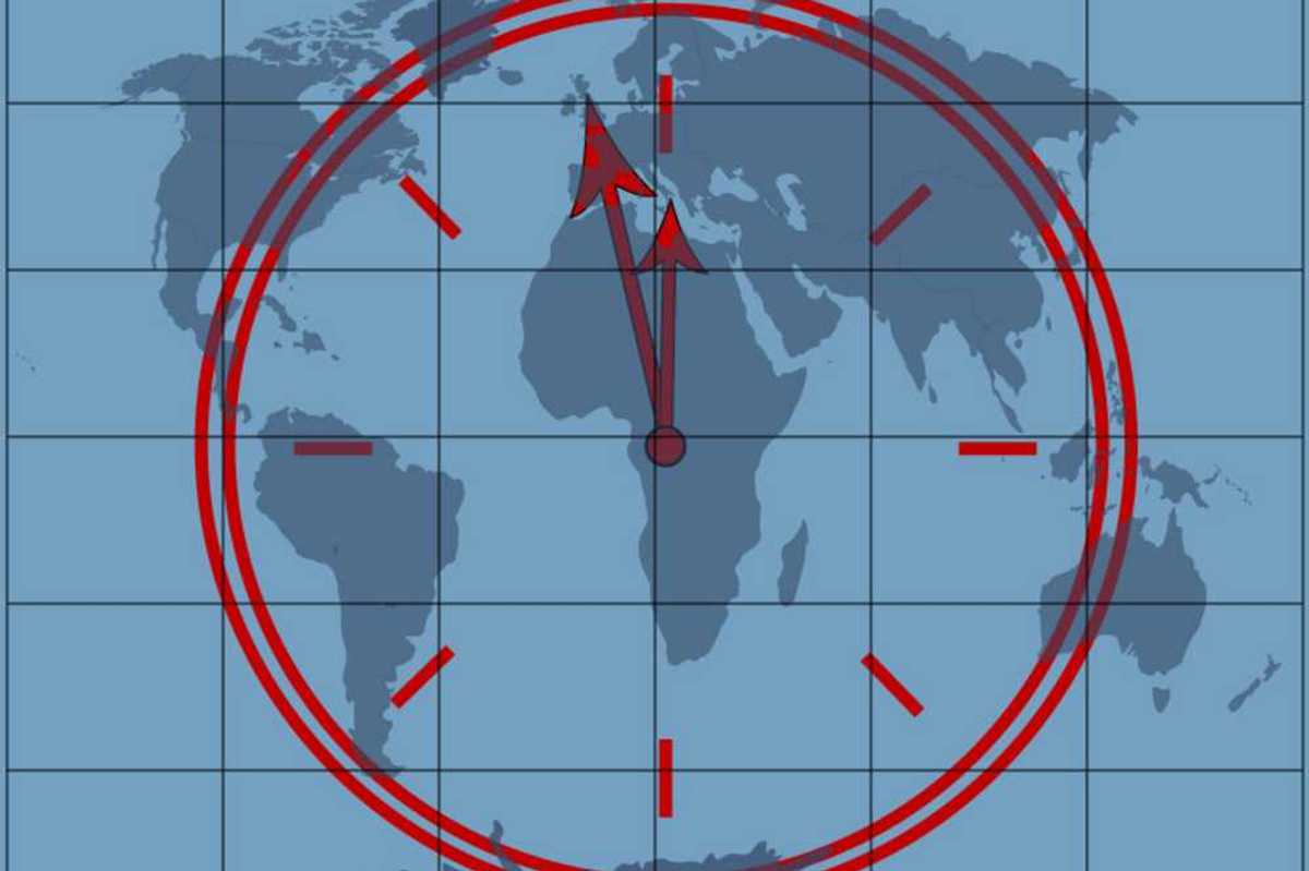 Clock approaching midnight superimposed over a world map