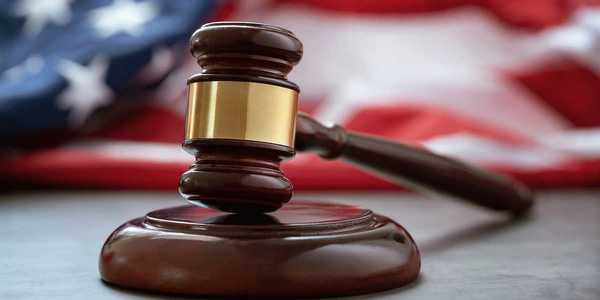 Close up of wooden judge gavel over the american flag