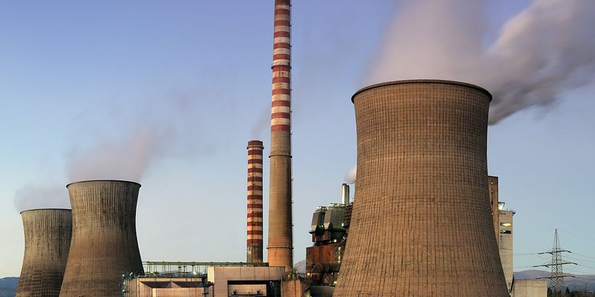 Coal fire power plant with towers and smokestacks.