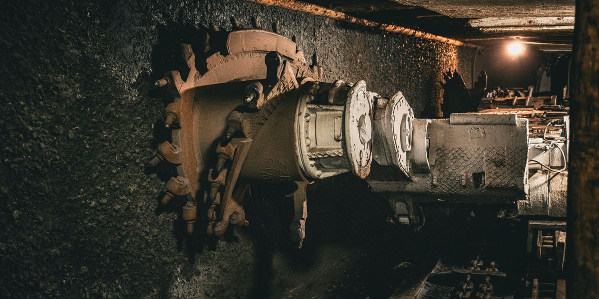 Coal mining equipment digging into a coal seam.