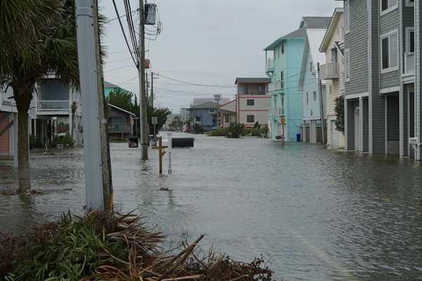 Coastal street flooding on Carolina Beach, NC during king tide.