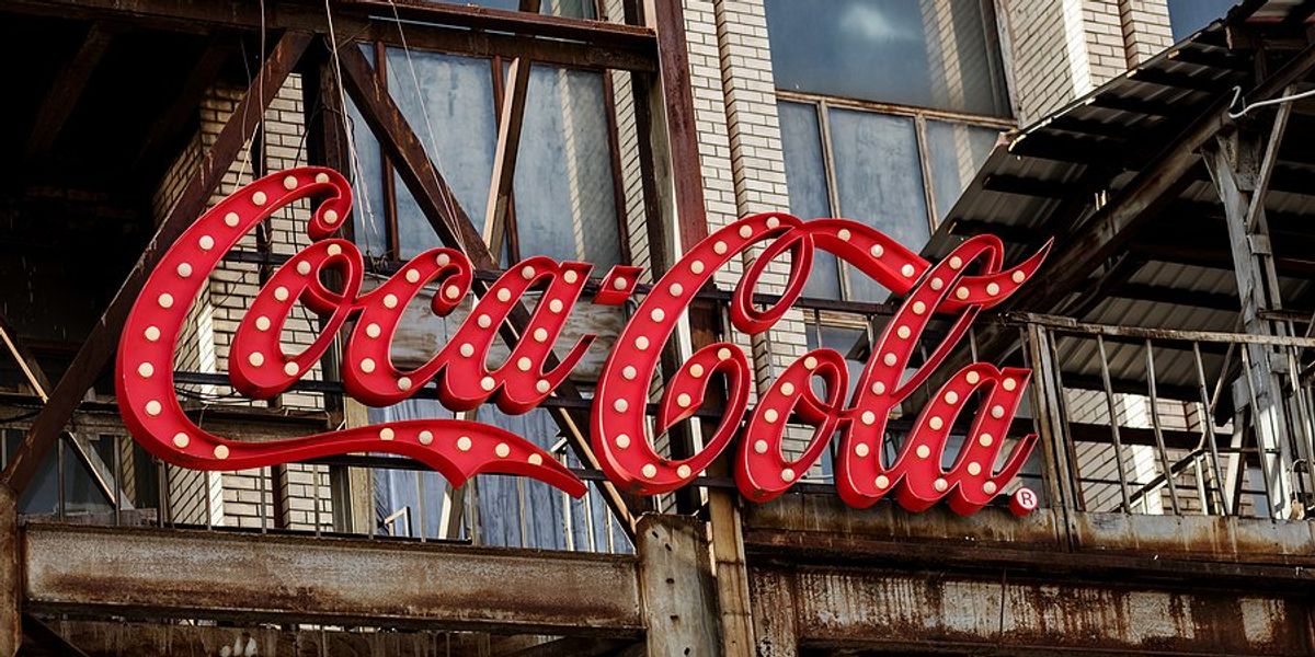 Coca Cola logo on the side of a building.