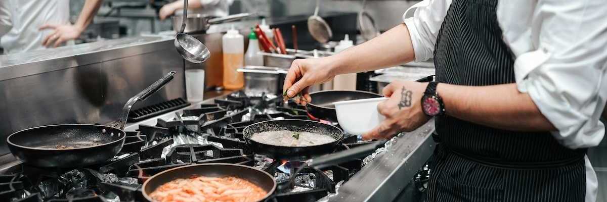 Commercial gas range in use in restaurant kitchen