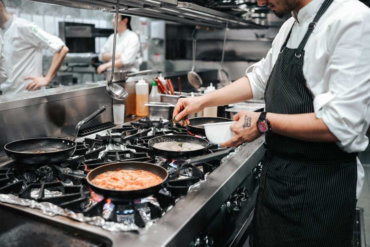 Commercial gas range in use in restaurant kitchen