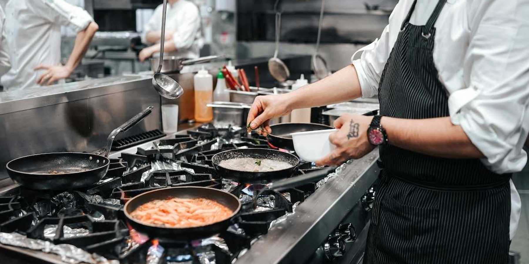 Commercial gas range in use in restaurant kitchen