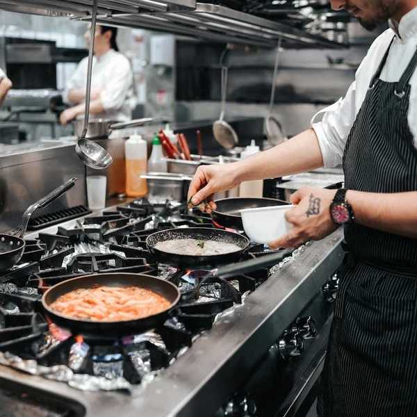 Commercial gas range in use in restaurant kitchen