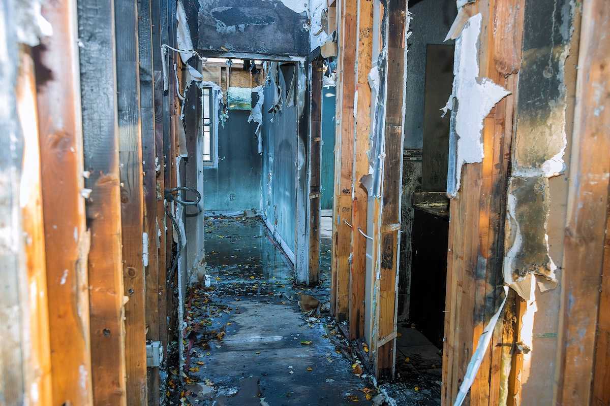 Completely burnt wooden house consequences of fire in California USA