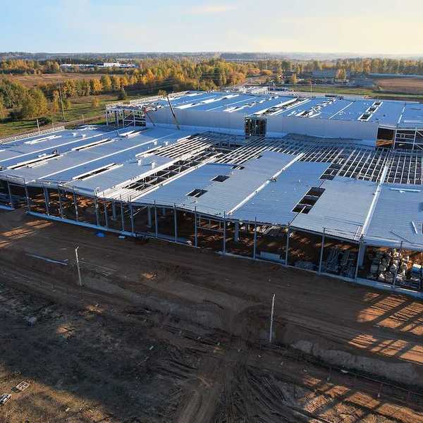 Construction site with steel structure warehouse.