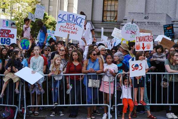 Crowd of mostly children and adults demonstrate displeasure over anti-science, anti-climate, policies.