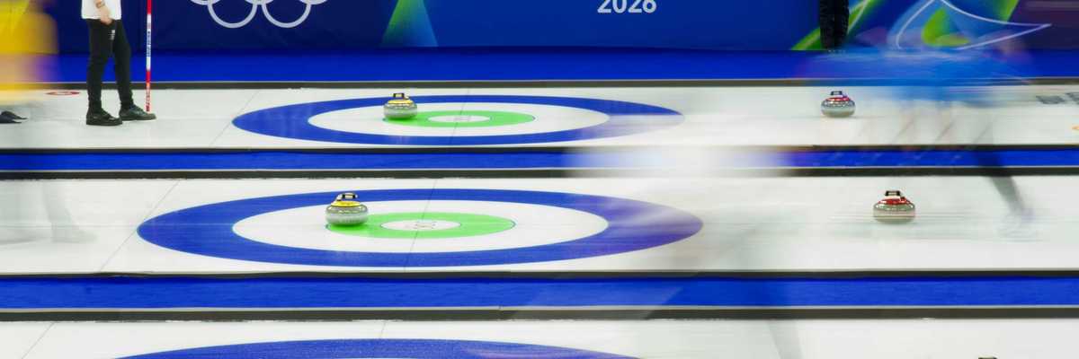 Curling match at Cortina Winter Olympics 2026 with athletes sliding stones on ice and fans in stands behind.