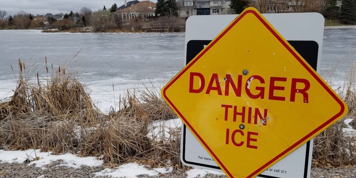 Danger Thing Ice sign near frozen lake