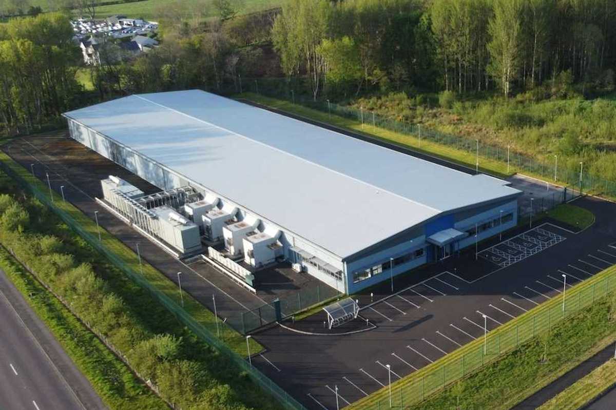 Data Center white industrial building in a green, bucolic rural setting