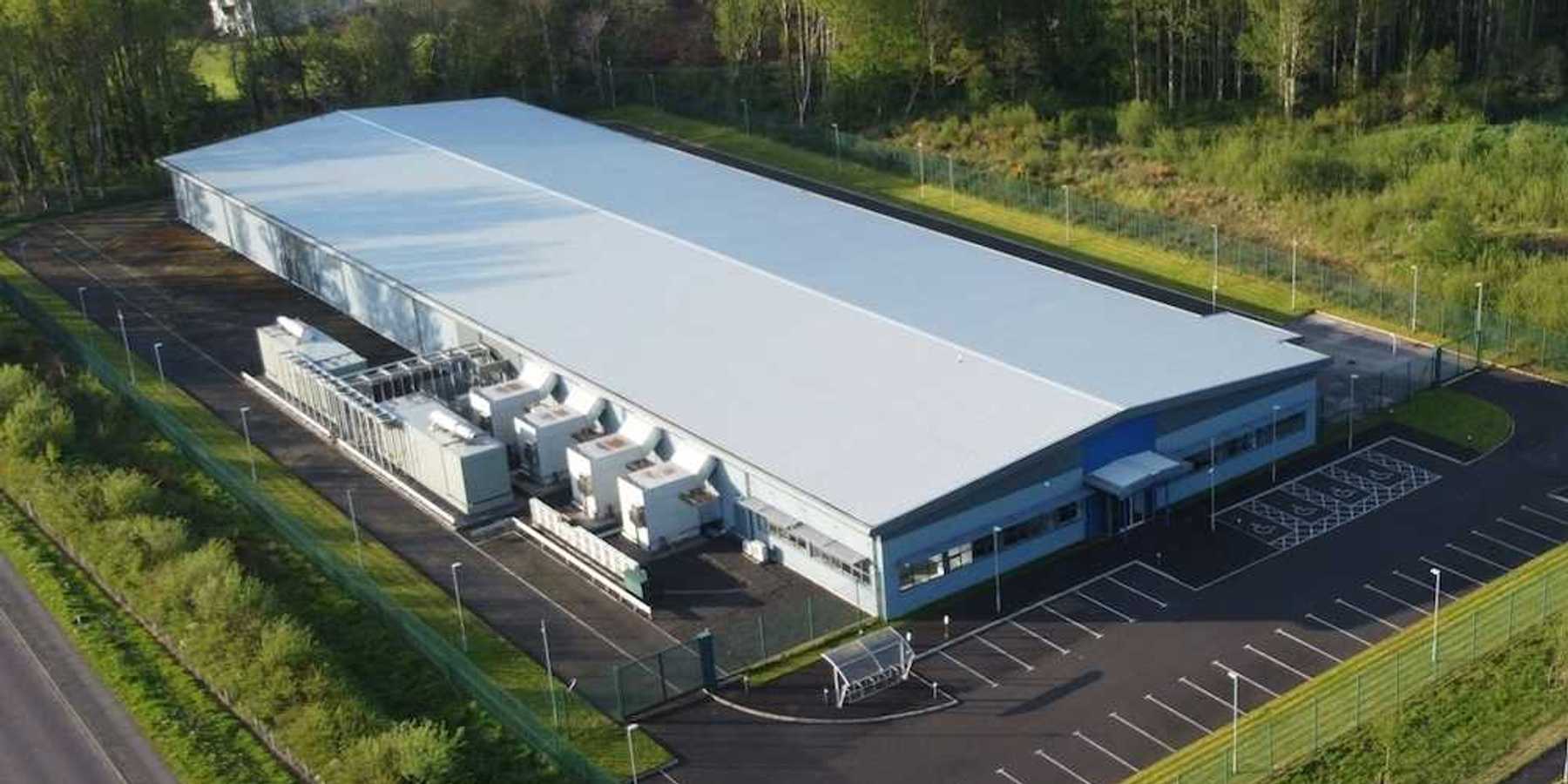 Data Center white industrial building in a green, bucolic rural setting