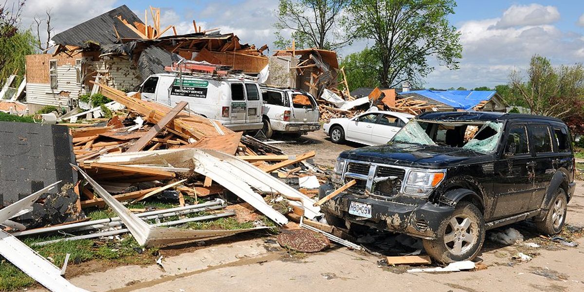 Demolished house and cars after a tornado.