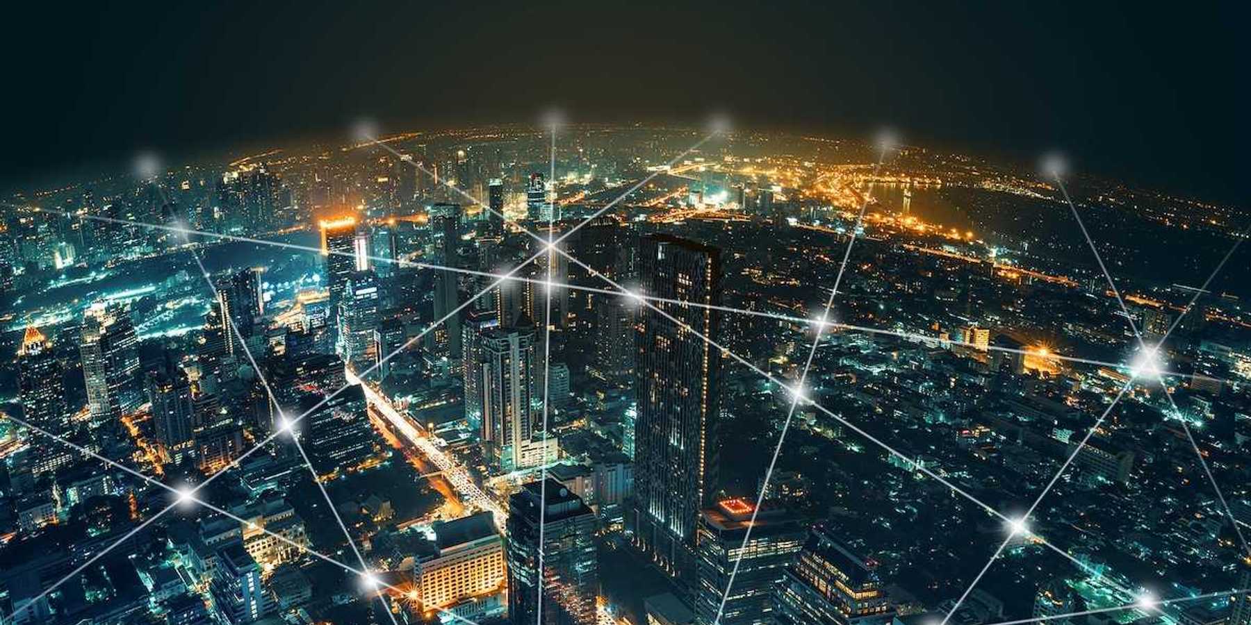 Depiction of network and connection technology on a night city background at business center bangkok thailand.