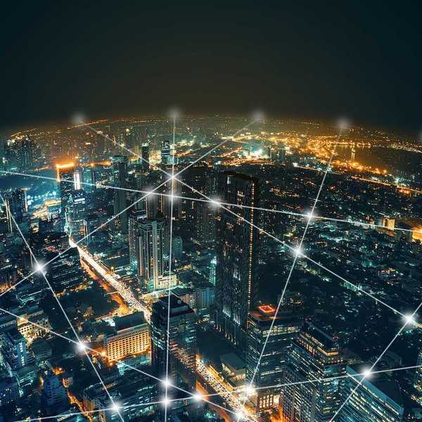 Depiction of network and connection technology on a night city background at business center bangkok thailand.