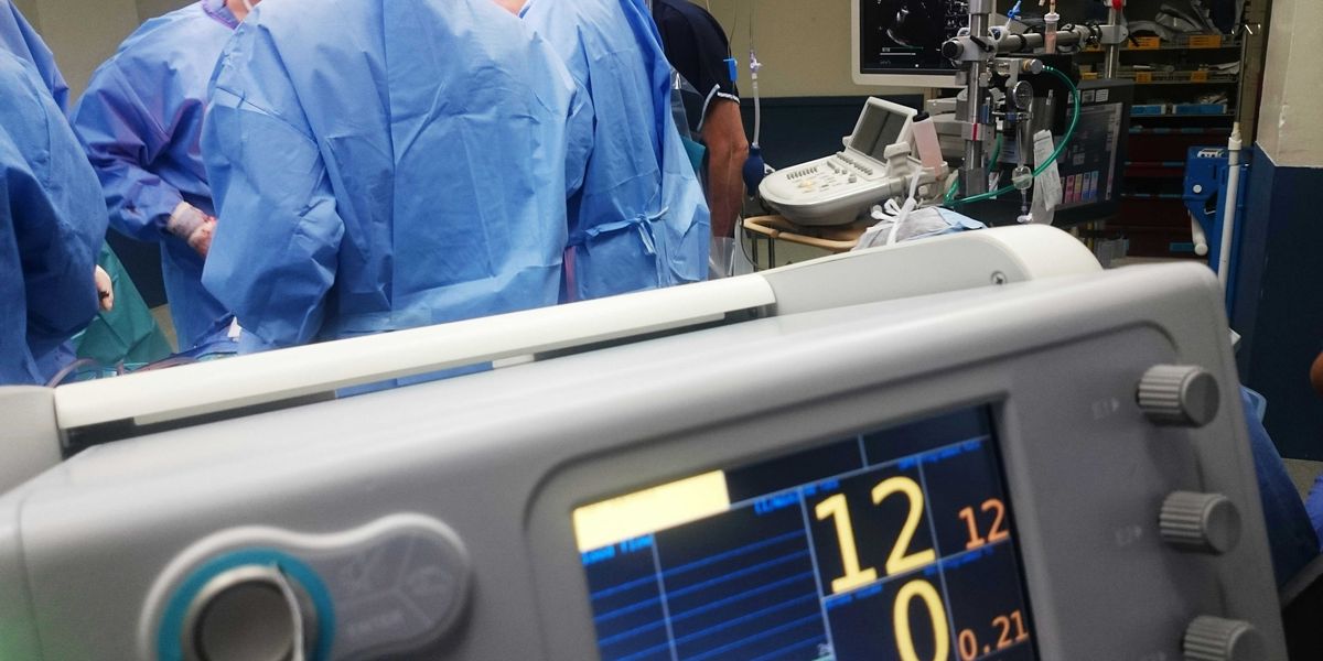 doctors doing surgery inside emergency room.