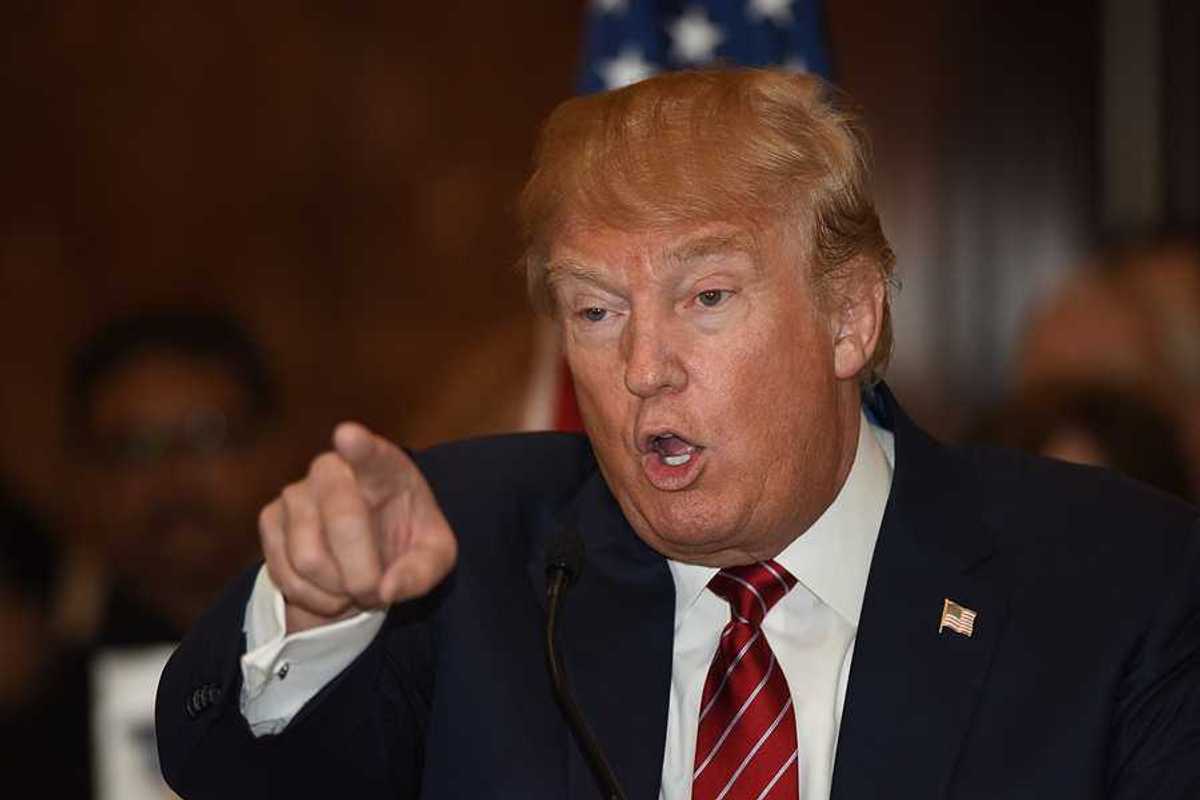 Donald Trump pointing finger and gesturing in a threatening manner