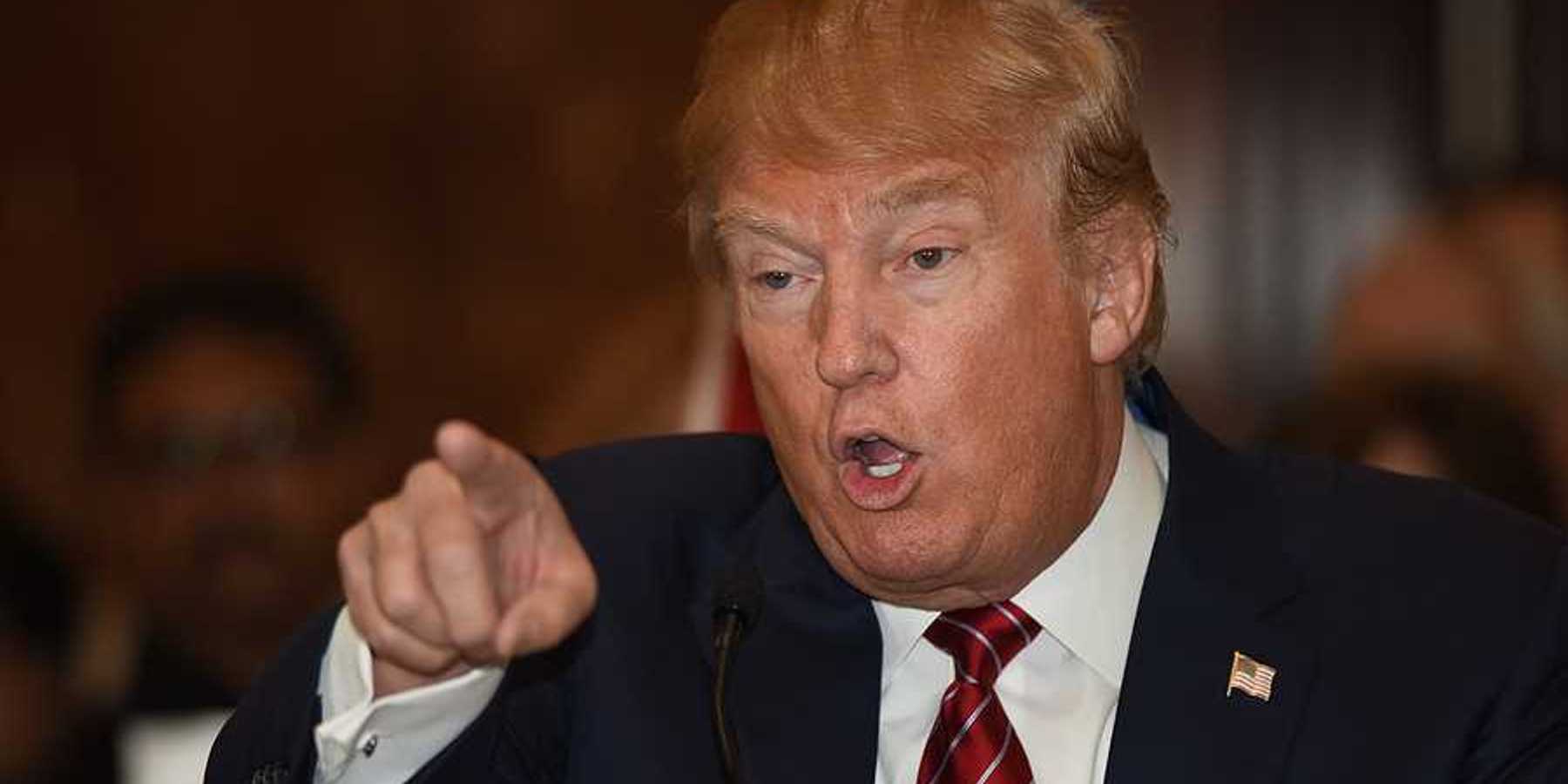 Donald Trump pointing finger and gesturing in a threatening manner