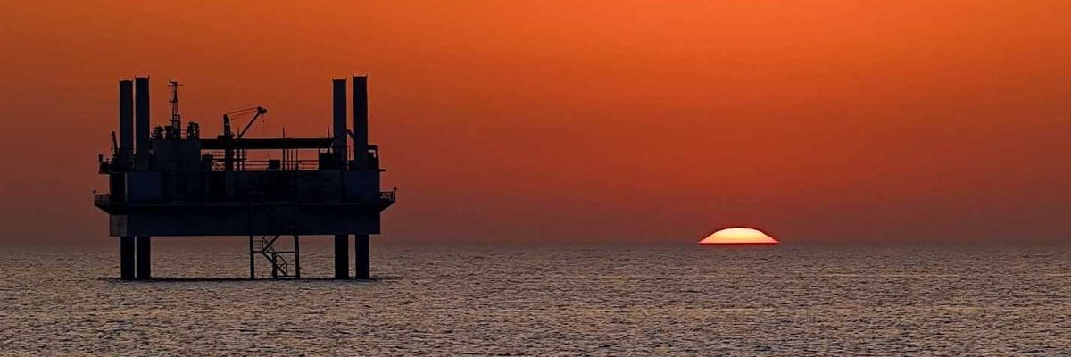 drilling platform against colorful sunset