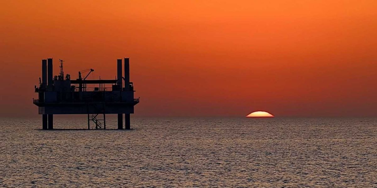 drilling platform against colorful sunset