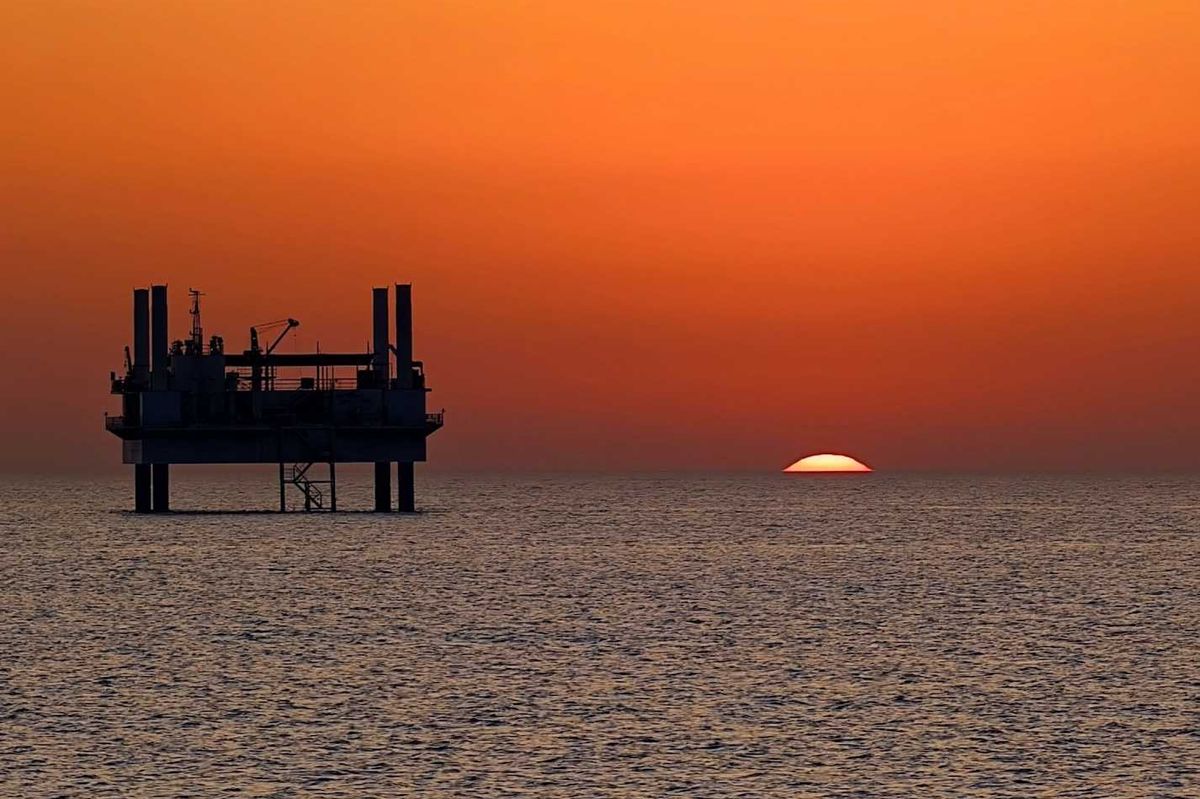 drilling platform against colorful sunset