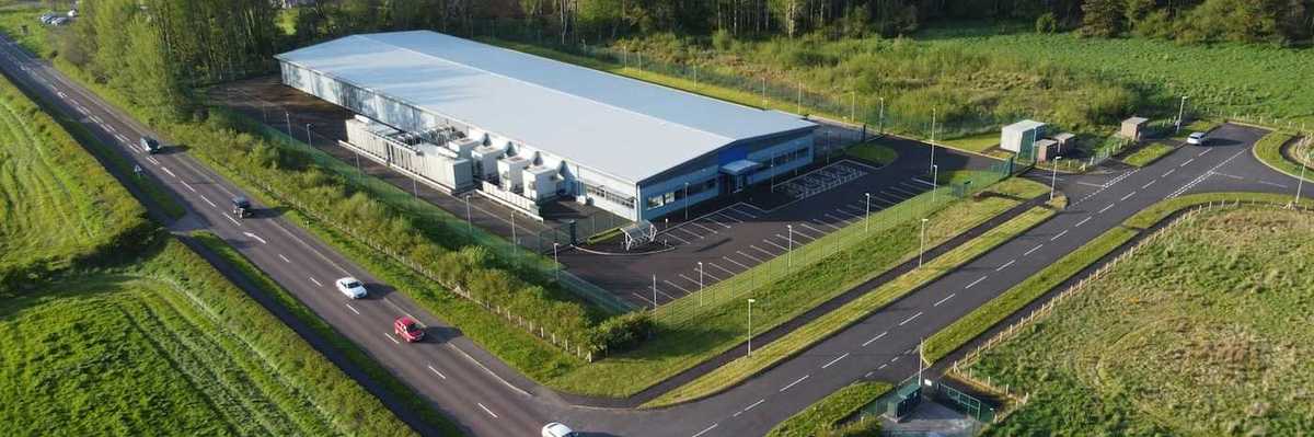 Drones-eye-view of a data center in rural countryside.