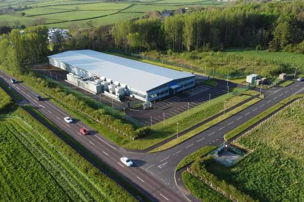 Drones-eye-view of a data center in rural countryside.