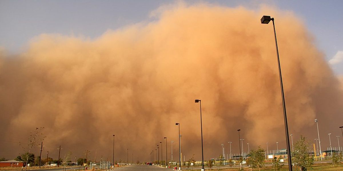 Dust storm approaching a town.