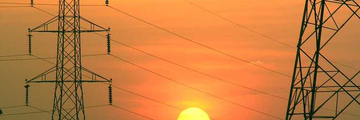 Electric towers with the sun in the background