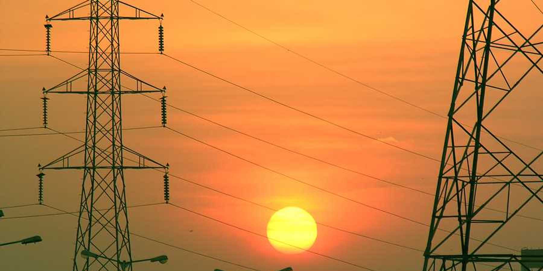 Electric towers with the sun in the background