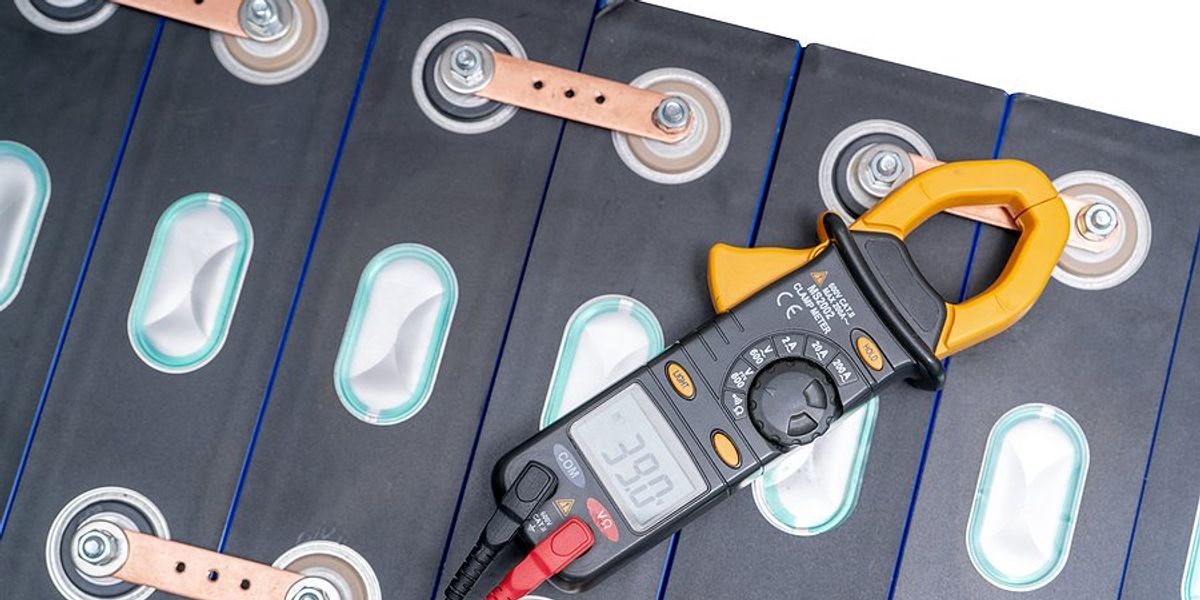 Electric vehicle battery with a monitor device plugged in.