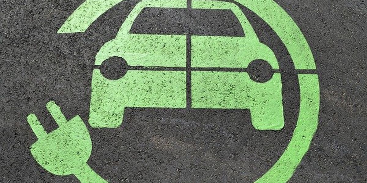 Electric vehicle charging logo on pavement