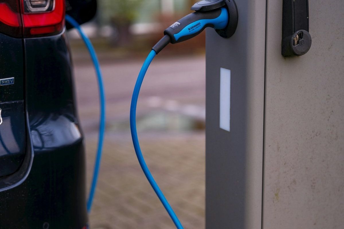 Electric vehicle plugged into charging station
